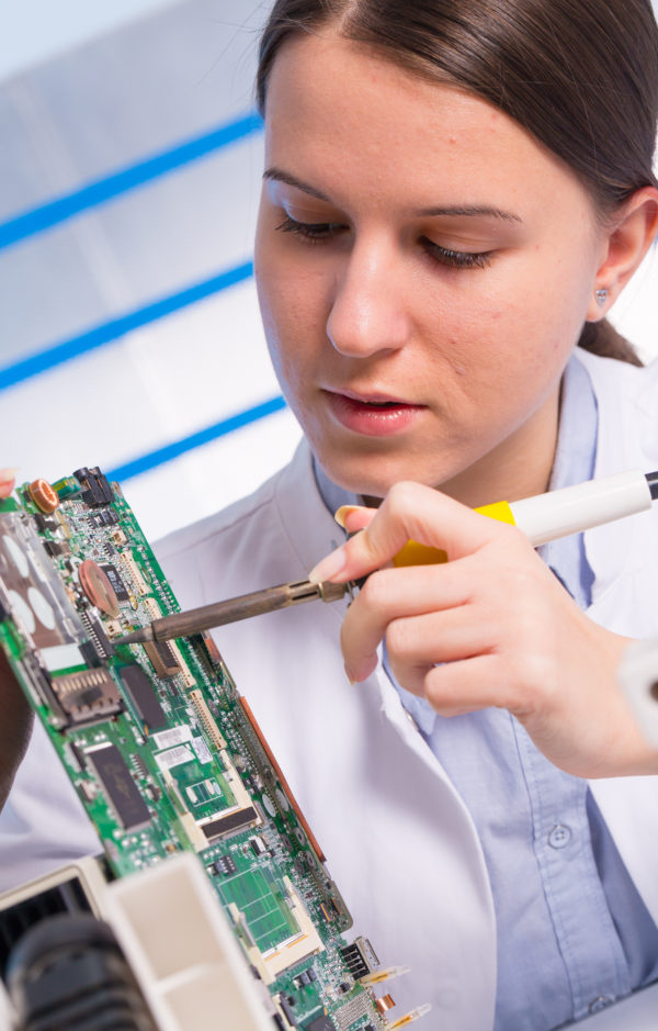 Young woman technician repair electronics device Young woman technician repair electronics device